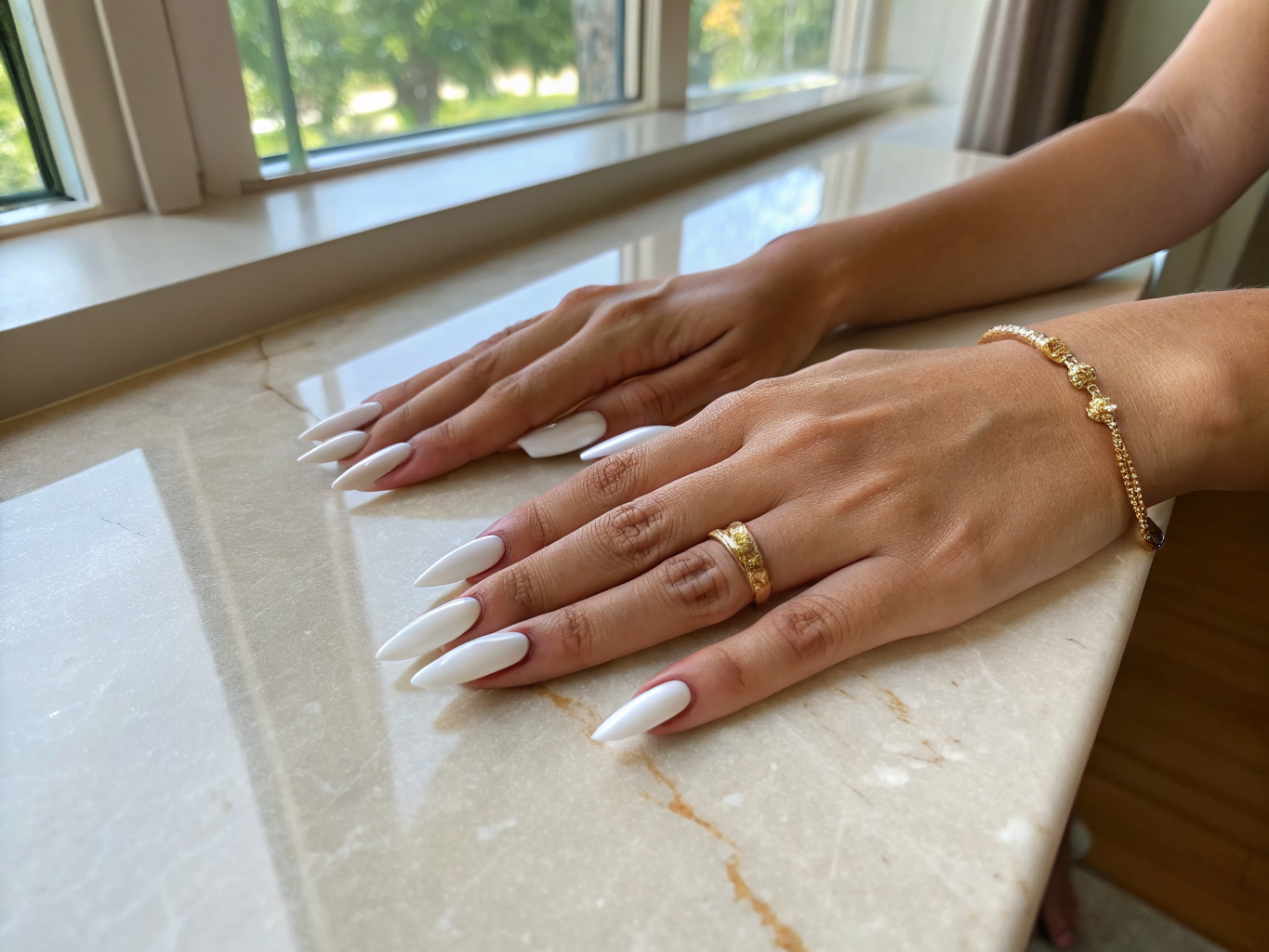 Elegantly sculpted almond acrylic nails with subtle gold foil accents